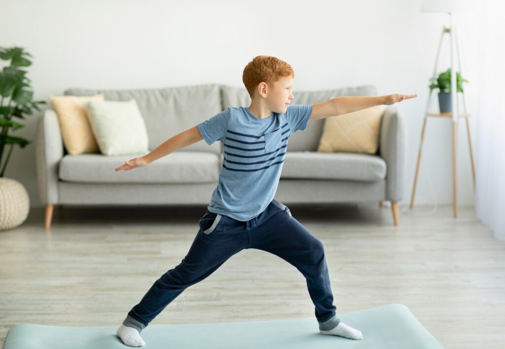 Cool redhead preteen boy doing yoga at home